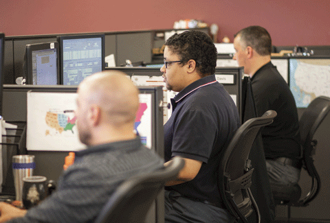 Agents at their desks in the office. Freight agent commission splits explained