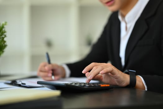 accountant-using-calculator-for-financial-analysis; financial planning for freight agents; Sureway