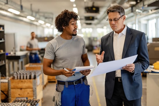 professionals-discussing-plans-in-an-industrial-workplace, Sureway, transportation, logistics, agents