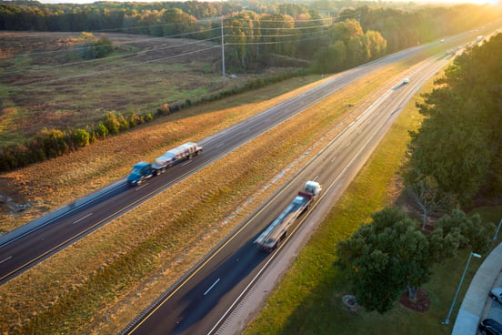 trucks-driving-on-a-road-at-sunset; moving my freight brokerage over to Sureway; Sureway Transportation Company